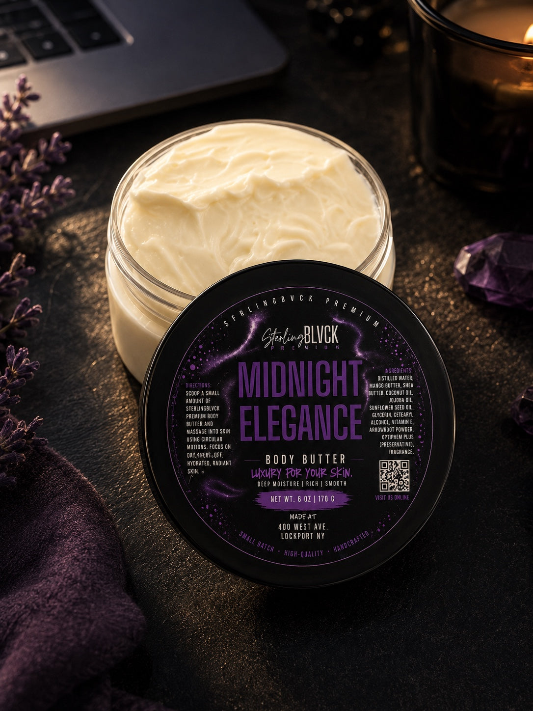 SterlingBLVCK Premium Midnight Elegance Body Butter with open jar, purple label, lavender and warm candlelight.