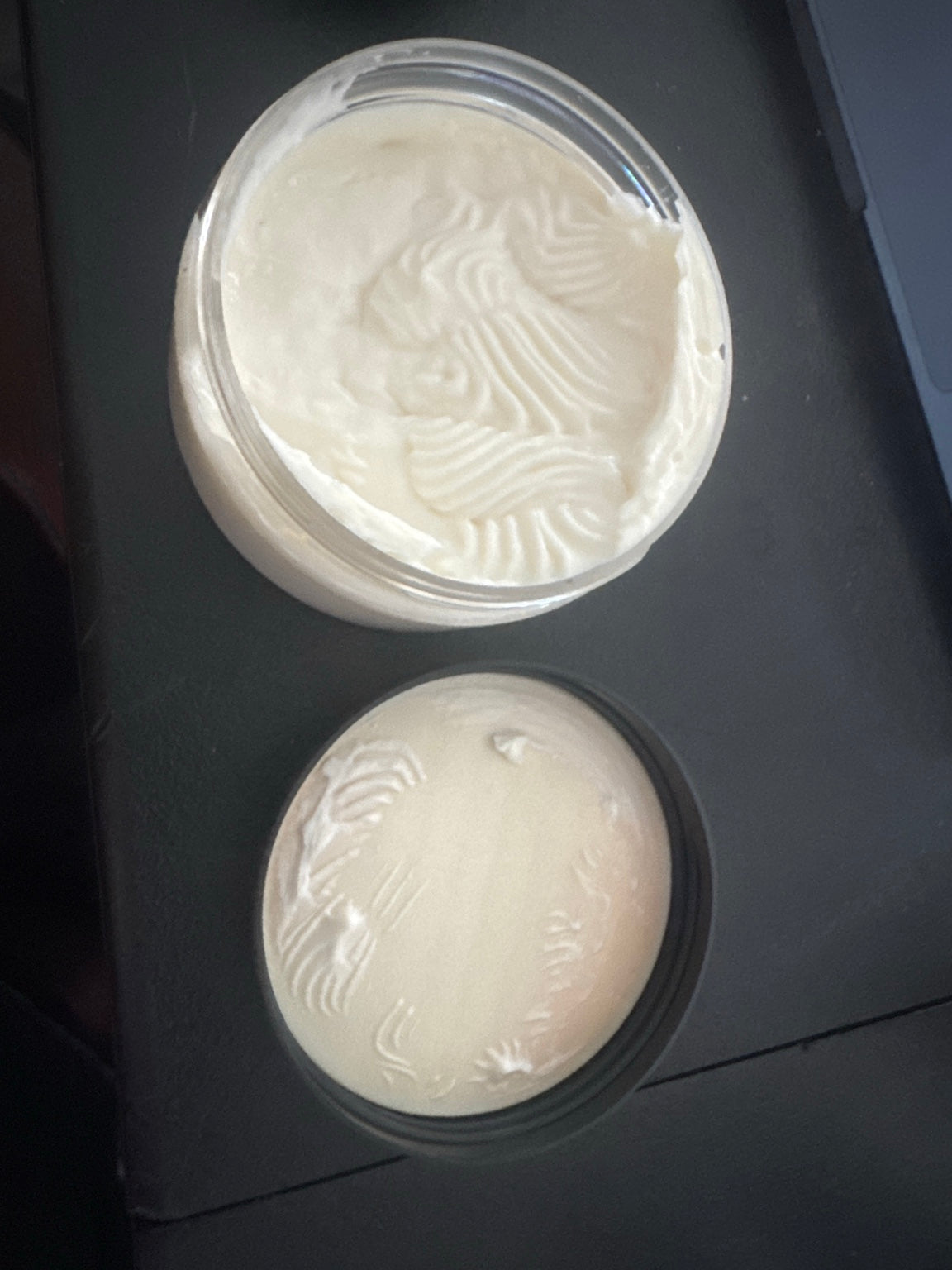 Close-up of SterlingBLVCK Premium body butter texture in an open jar, showing its rich whipped consistency.